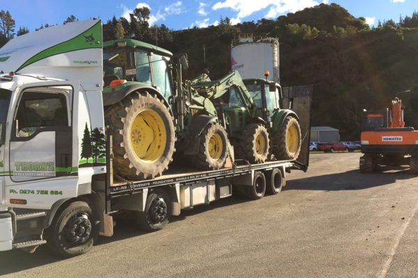 Thornz Landscaping Truck Transporting Two Large Tractors