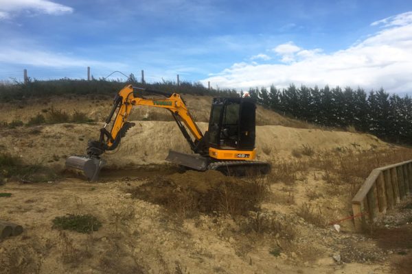 Thornz Landscapes Excavator On Site Clearing Land Behind Timber Retaining Wall