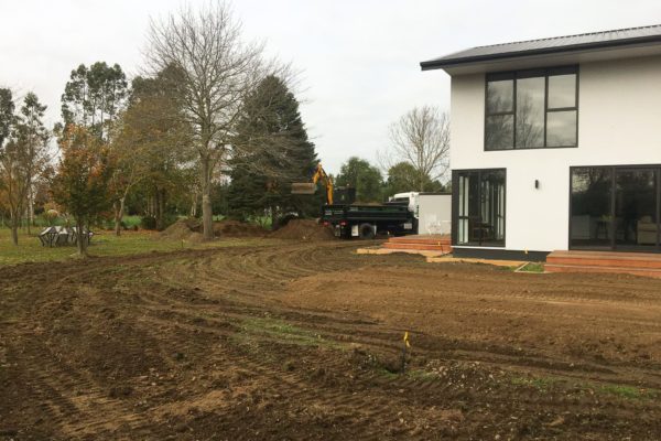 JCB And Truck Preparing Ground For Lawn Sowing And Fertilisation Of Large Lawn Area