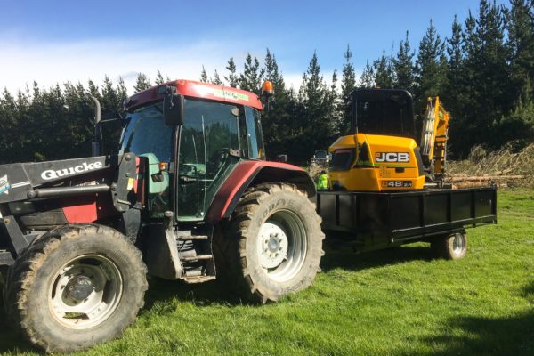 Thornz Landscapes Tractor Transporting Bobcat On Rural Earthworks Site