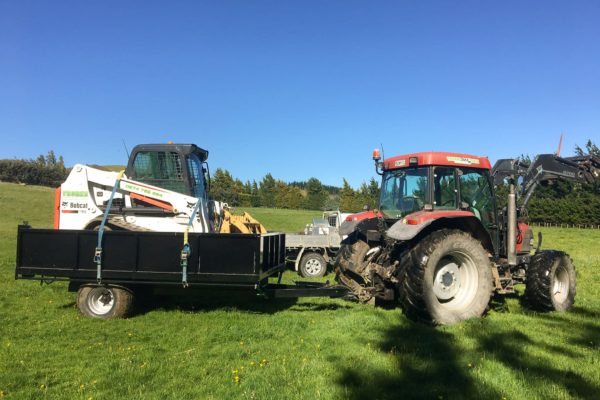 Thornz Landscapes Tractor Transporting Bobcat On Rural Earthworks Site