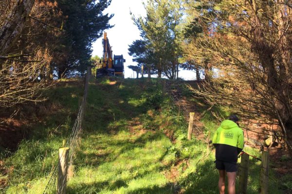 Thornz Landscapes Employees On Rural Site Removing Fencing To Make Way For Excavator To Create Stock Race Driveway